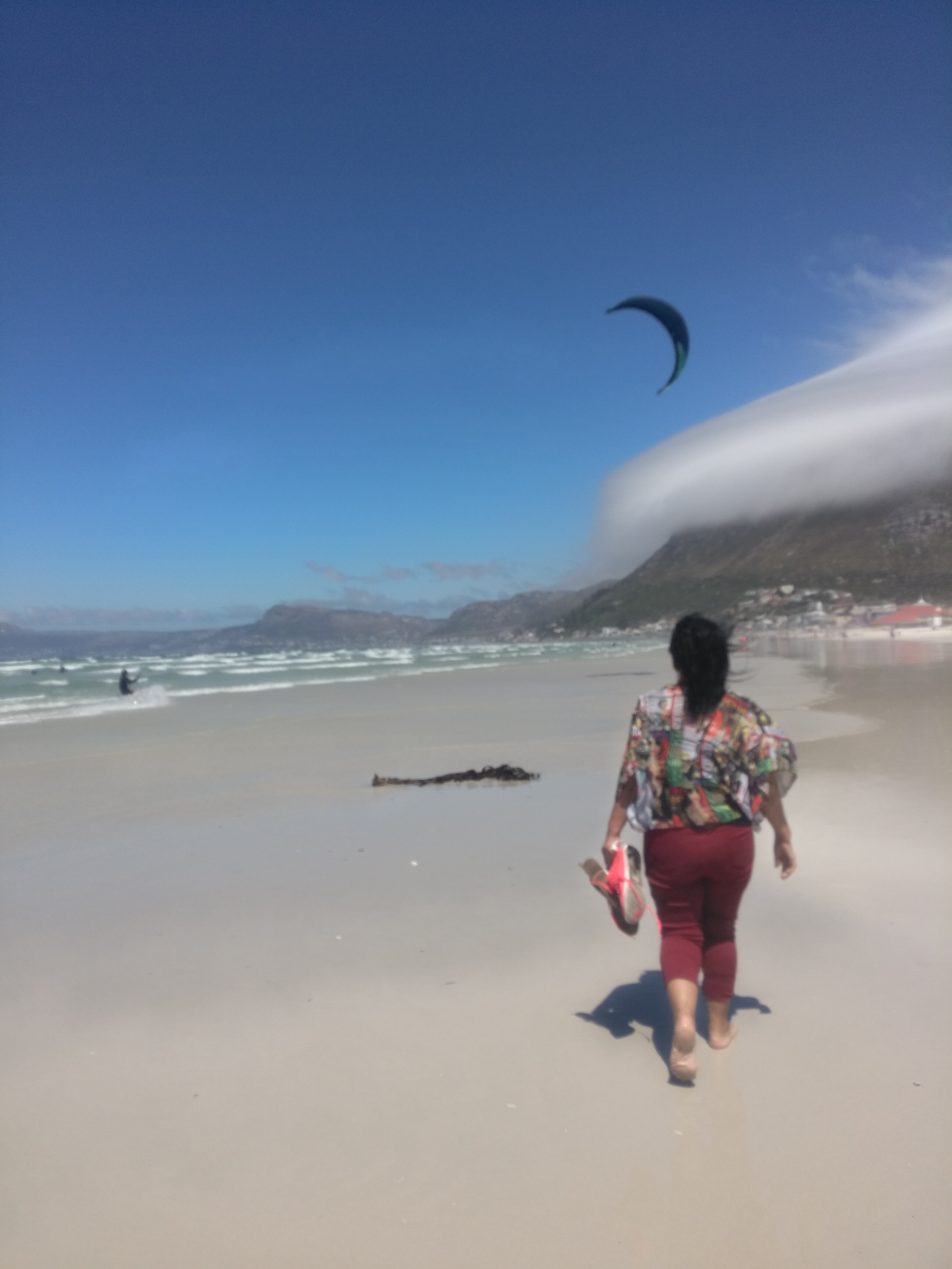 My mom walking at Muizenberg beach
